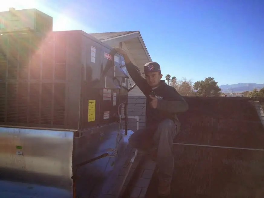 HVAC technician performing Boiler Repair on a rooftop unit in Scenic Oaks